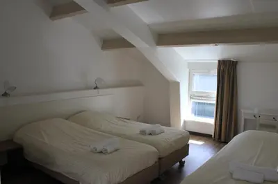 a bedroom with two beds with towels on them at Newhouse Logies in Zevenhoven