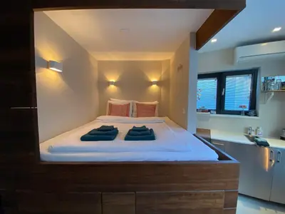 a bedroom with a large bed with two pillows on it at Houseboat Sophia in Amsterdam