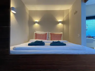 a large bed with two blue towels on it at Houseboat Sophia in Amsterdam