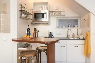a kitchen with a counter with stools in it at Luttik Oudorp 30 in Alkmaar