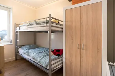 a bunk bed room with two bunk beds and a closet at Luttik Oudorp 30 in Alkmaar
