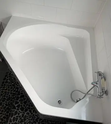 a white bath tub with a faucet in a bathroom at Amster Houseboat in Amsterdam