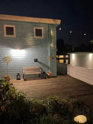 a bench sitting on a deck at night at Amster Houseboat in Amsterdam