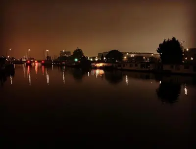 a city at night with a body of water at Amster Houseboat in Amsterdam