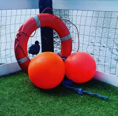 two orange balls and a life preserver on a boat at Amster Houseboat in Amsterdam