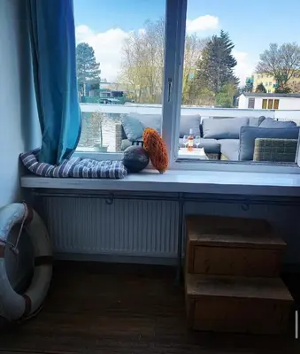 a window sill with a couch in a living room at Amster Houseboat in Amsterdam
