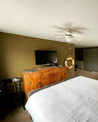 a bedroom with a bed and a flat screen tv at Amster Houseboat in Amsterdam