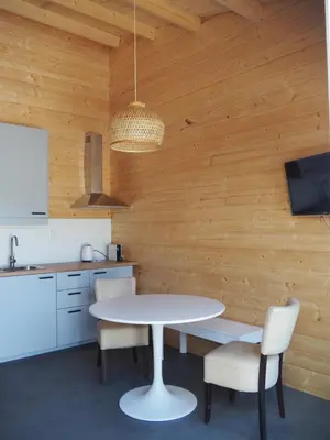 a kitchen with a white table and chairs at Polderlodge in Hillegom