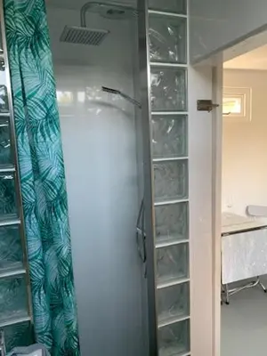a glass door to a shower in a bathroom at King almost by the sea in Zandvoort
