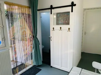 a room with a door with three birds on it at King almost by the sea in Zandvoort