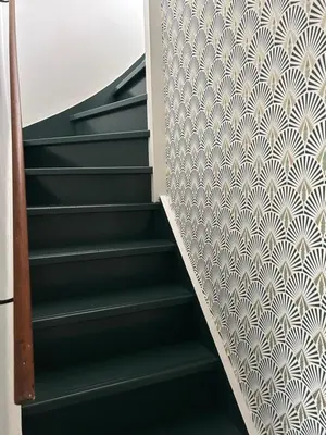 a staircase with a geometric pattern on the wall at King almost by the sea in Zandvoort