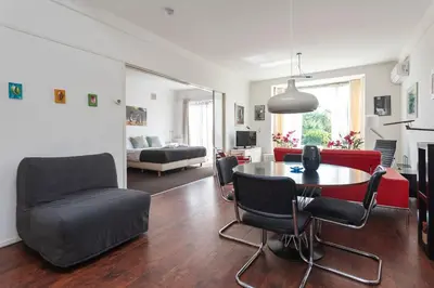 a living room with a table and chairs and a couch at Apartment De Drie Tulpen in Zandvoort