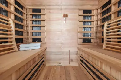 a sauna with wooden walls and wooden shelves at Apartment De Drie Tulpen in Zandvoort