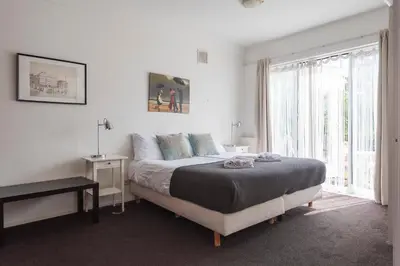 a bedroom with a bed and a large window at Apartment De Drie Tulpen in Zandvoort