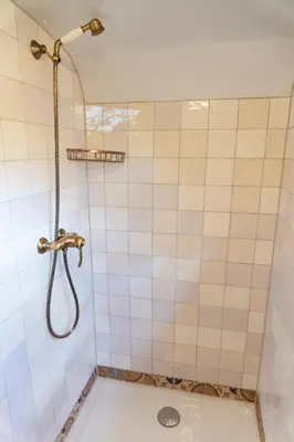 a bathroom with a shower with a shower head at De Wagen in Egmond-Binnen