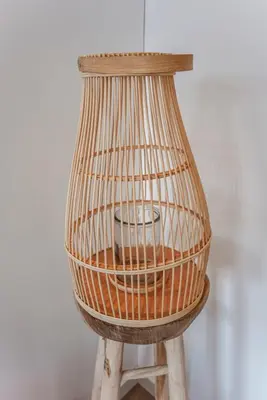 a bird cage sitting on top of a wooden stool at Little Buddha in Zandvoort