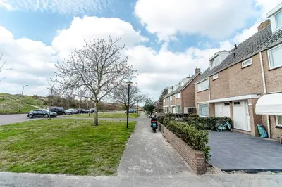 a motorcycle parked on a sidewalk next to a house at Little Buddha in Zandvoort