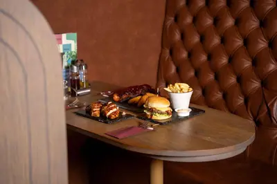 a table with a sandwich and other food on it at The Florian Amsterdam Schiphol Airport, WorldHotels Crafted in Hoofddorp