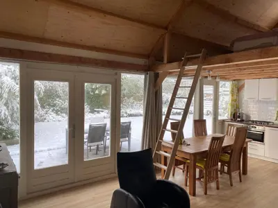 a kitchen and dining room with a table and chairs at Garden find zandvoort in Bentveld