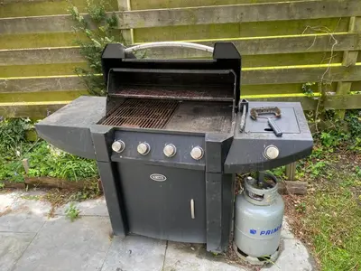 a grill sitting on a sidewalk next to a fire extinguisher at Garden find zandvoort in Bentveld