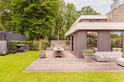 a garden with a patio and a house at Villa Merici in Bergen