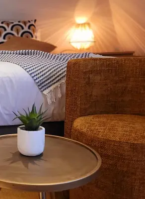 a table and a chair next to a bed at Dream Boutique Edam Bed & Coffee in Edam