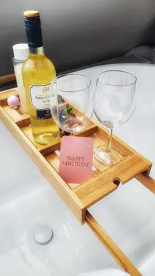 a wooden tray with two glasses and a bottle of wine at Dream Boutique Edam Bed & Coffee in Edam