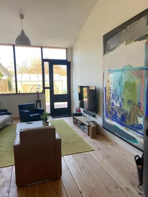 a living room with a couch and a tv at Luca’s Loft in Bergen