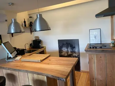 a kitchen with a wooden table in a room at Luca’s Loft in Bergen