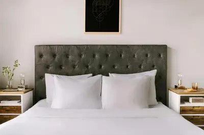 a bedroom with a large bed with white pillows at S&A Vondel Park Hotel in Amsterdam