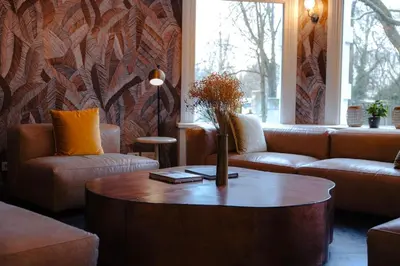 a living room with couches and a coffee table at S&A Vondel Park Hotel in Amsterdam