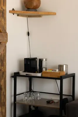 a shelf with glasses and a microwave on a wall at BnB Purmerland in Purmerend