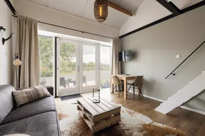 a living room with a couch and a table at BnB Purmerland in Purmerend