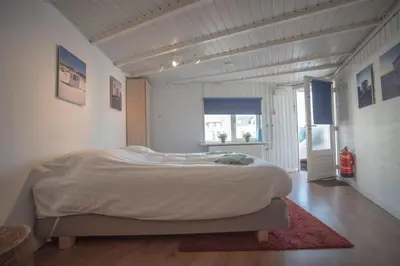 a bedroom with a large bed in a room at Stop & Stay 2 in Zandvoort