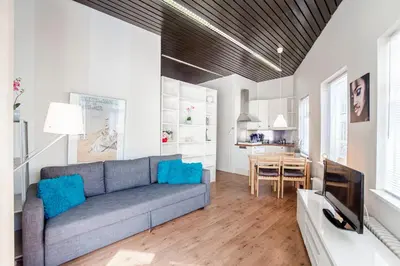 a living room with a couch and a dining room at Stop & Stay 1 in Zandvoort