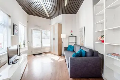 a living room with a couch and a tv at Stop & Stay 1 in Zandvoort