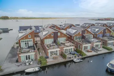 an aerial view of a large house on the water at Meerzicht 70 - Vakantiehuis aan het water! in Uitgeest