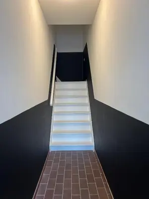 a staircase in a building with white steps at Pure Apartment in Zandvoort