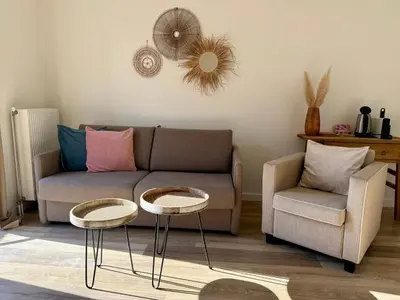 a living room with a couch and a chair at Pure Apartment in Zandvoort