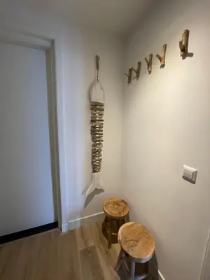 a room with two stools and a skeleton on the wall at Pure Apartment in Zandvoort