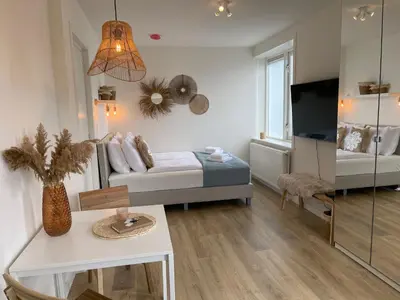 a small living room with a bed and a couch at Pure Studio in Zandvoort