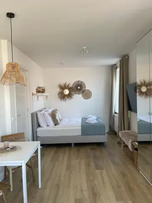 a room with a bed and a table in it at Pure Studio in Zandvoort