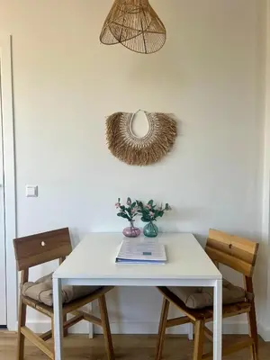 a white table with two chairs and a mirror at Pure Studio in Zandvoort