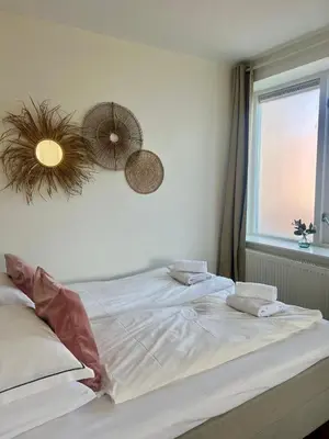 a white bed in a bedroom with a window at Pure Studio in Zandvoort