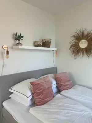 a bed with three pillows on top of it at Pure Studio in Zandvoort