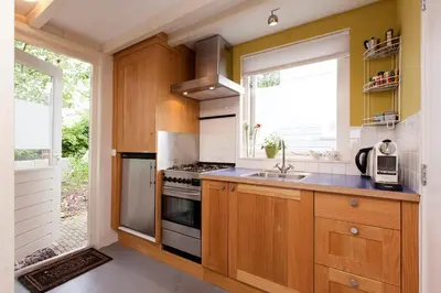a kitchen with a sink and a stove top oven at Lovely holiday house in Durgerdam in Amsterdam