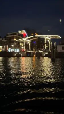 a lit up building on the water at night at Lovely holiday house in Durgerdam in Amsterdam