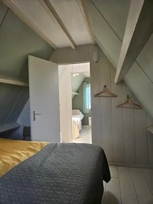 a bedroom with a bed and a room with a bed sqor at Lovely holiday house in Durgerdam in Amsterdam