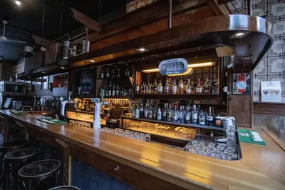 a bar with a lot of bottles of alcohol at Hotel & bar Royal taste Amsterdam in Amsterdam