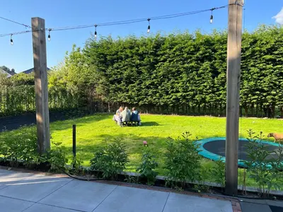 a group of people sitting in a yard at Paauwze in Rijnsburg